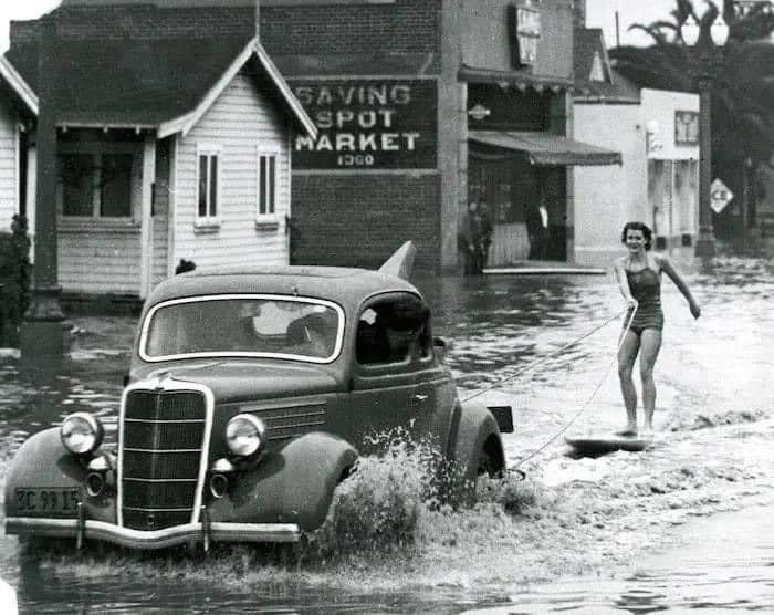 Mary Anne Hawkins surfing the flooded streets of Long Beach, California. 1940s