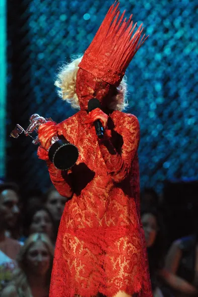 Lady Gaga wore Alexander McQueen's red lace dress when she accepted her  2009 Best New Artist VMA for "Poker Face." Gaga's red dress was from Alexander  McQueen Fall 1998 collection.