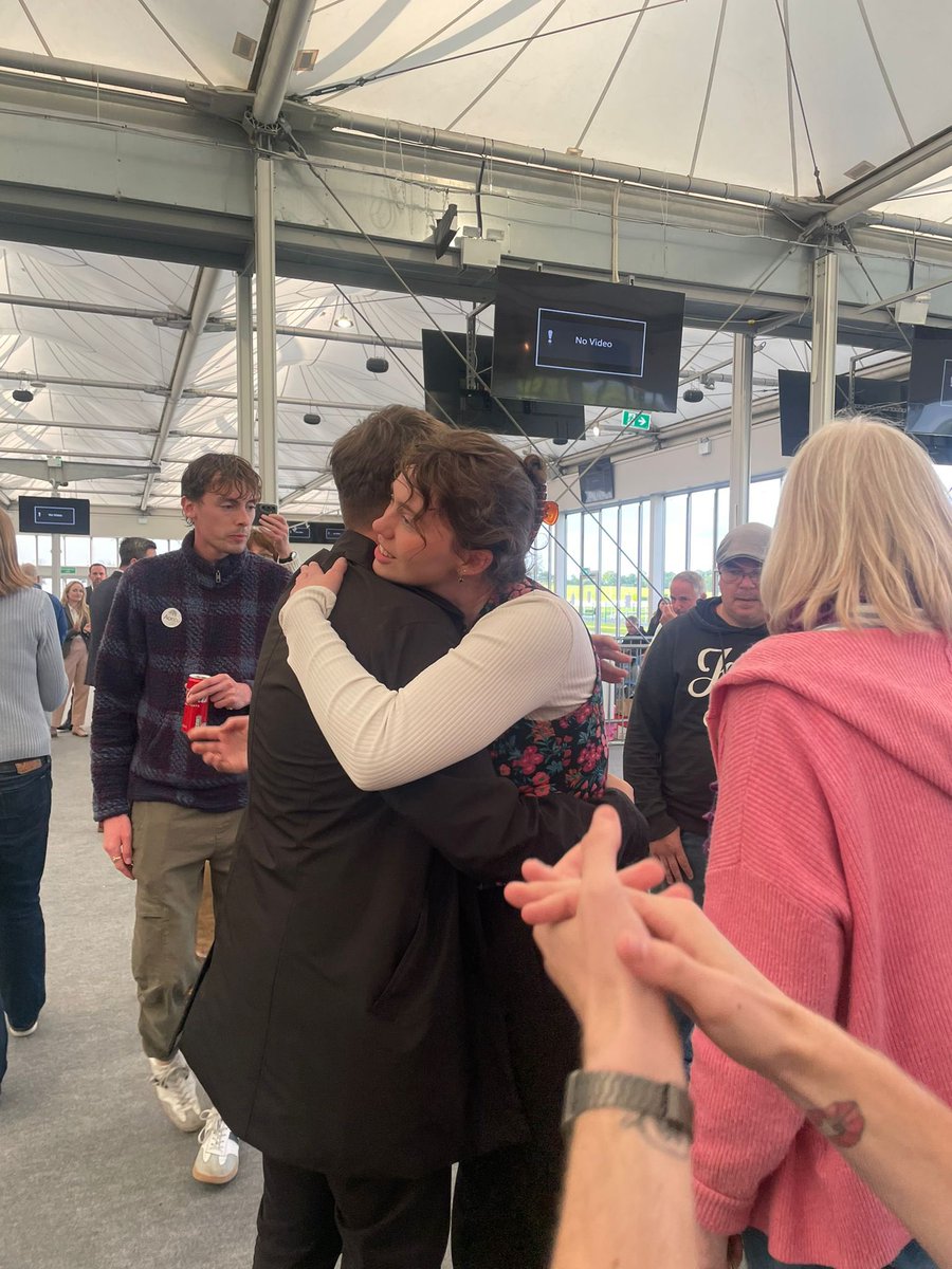 BarryLenihan's tweet photo. Aontu’s Melissa Byrne embraces Sinn Fein's James Stokes after a second recount in Newbridge finds their votes were exactly equal

Candidate with lowest first preference vote (Stokes) is eliminated

The 18-year old member of Traveller community was 1 vote behind &amp; then 1 vote up https://t.co/85XDcYCV8q