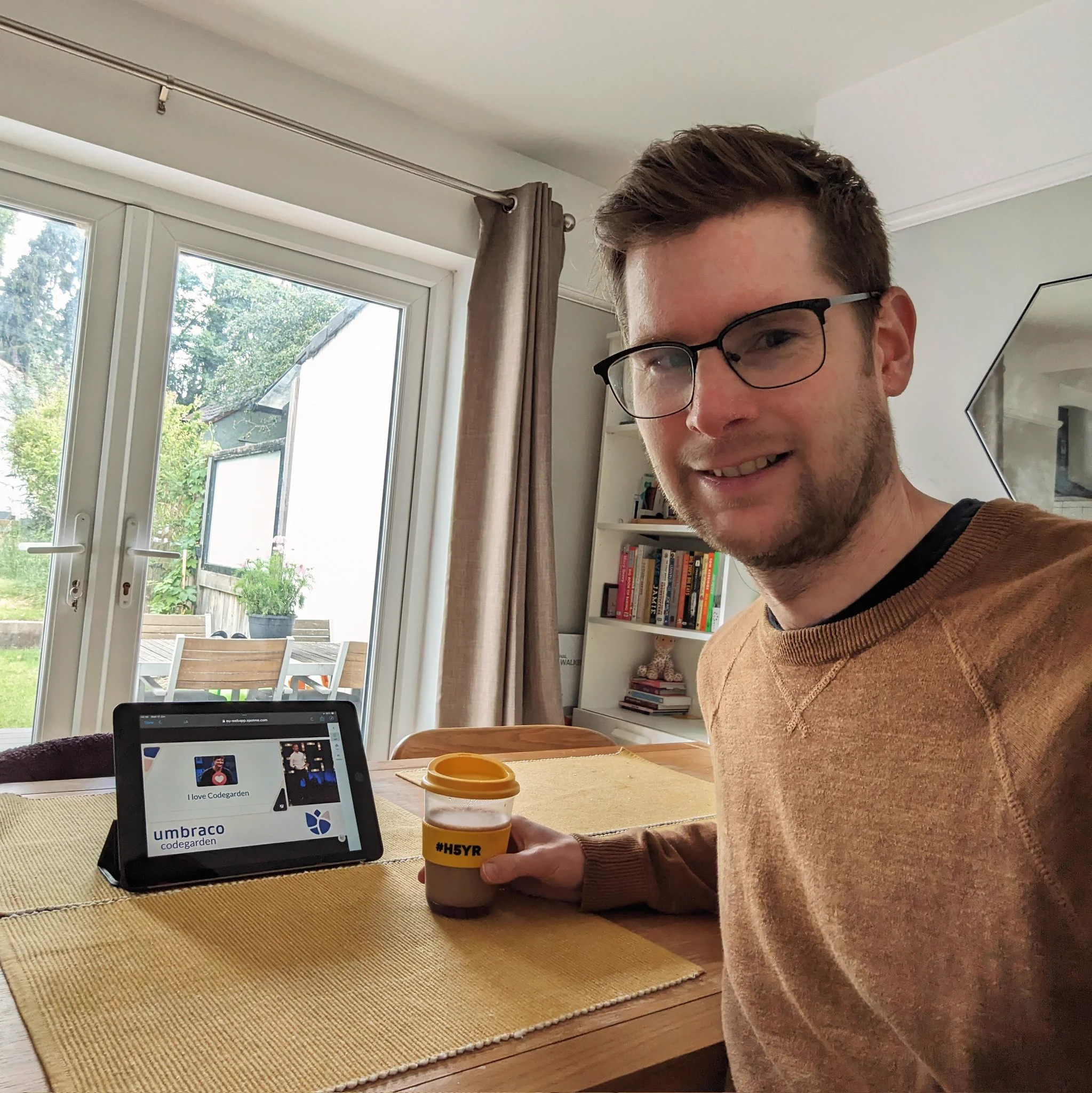 Thomas is watching umbraco codegarden from the comfort of his home, on his iPad with a #h5yr coffee cup in hand.