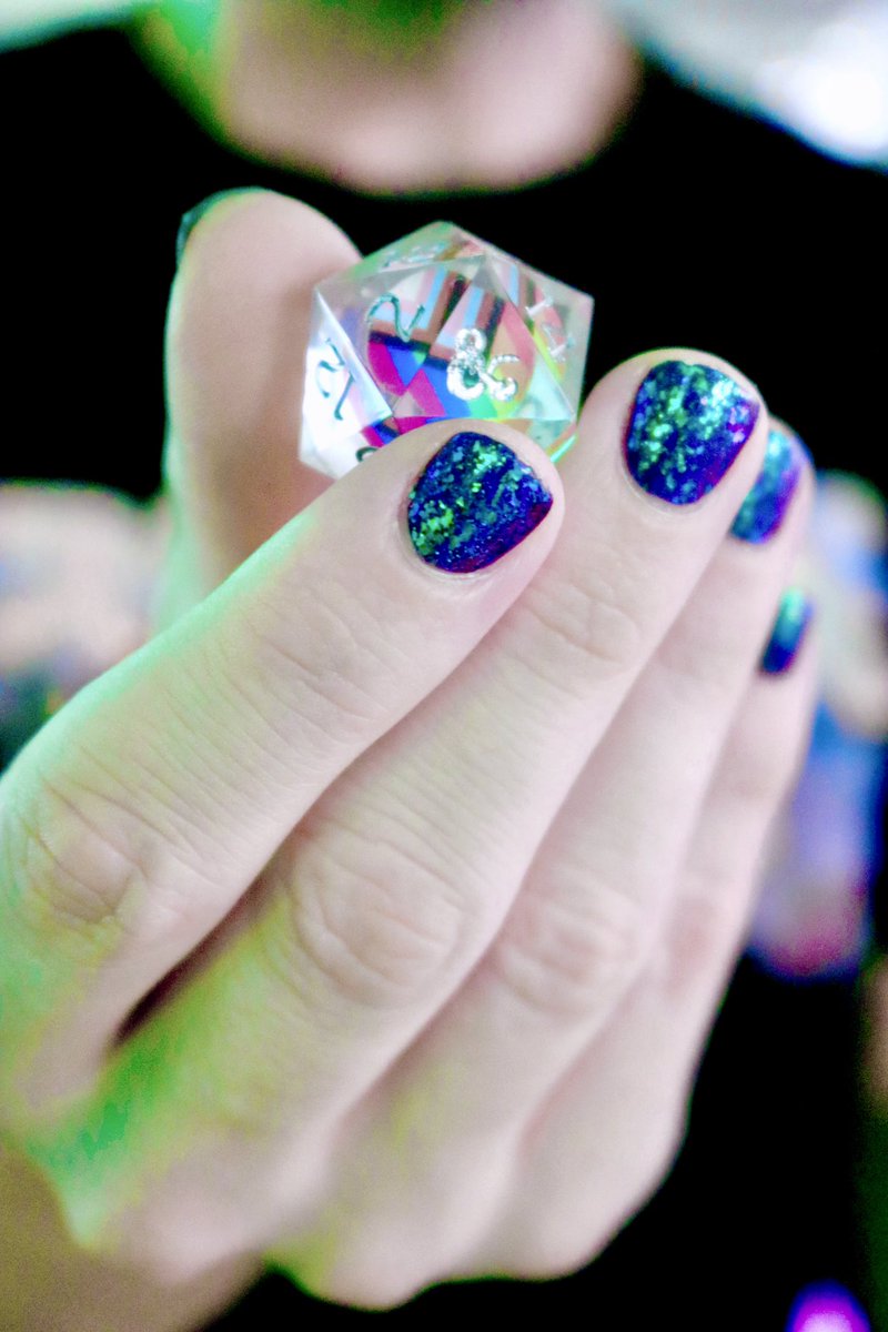 Xanderrific's tweet photo. Thank you to @Wizards_DnD and @MTGProShop for this year’s #Pride shirt, featuring gorgeous art by @rbessaaa, and a set of Progress Pride Dice designed by @danielquasar! #RollWithPride 
🎨Art: @rbessaaa
💅Nails: @holotaco by @/duckyleroux (📸)
🎲Dice: @SiriusDice by @danielquasar https://t.co/QD631JTbki