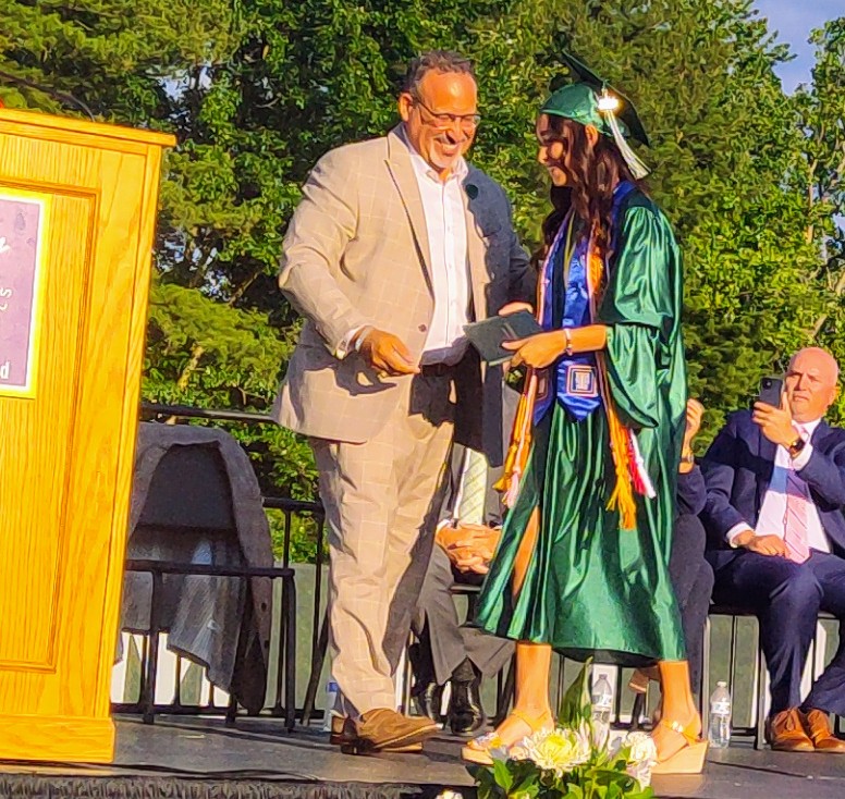CConnBiz's tweet image. U .S. Sec. Of Education Miguel Cardona shares a laugh with his daughter Celine as she walks the stage at Maloney High School tonight in Meriden.