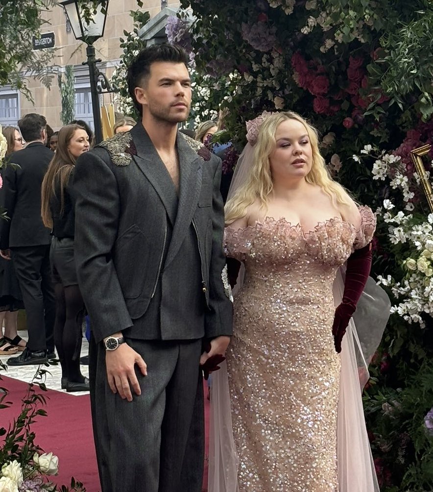 the embellishments on his suit matching her gloves