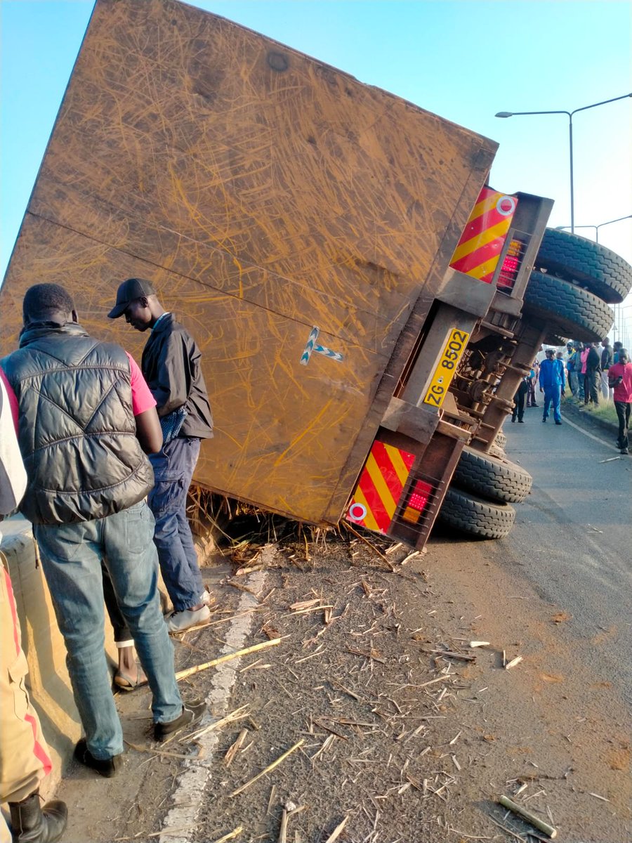 StJohnKenya's tweet photo. A truck transporting sugarcane has overturned at Nyamasaria Flyover in Kisumu leaving the driver with injuries. St John Ambulance team on standby nearby have responded to the incident. No fatalities or other injuries reported. Scene secured by Kisumu traffic control. https://t.co/w3Wubw5SIp