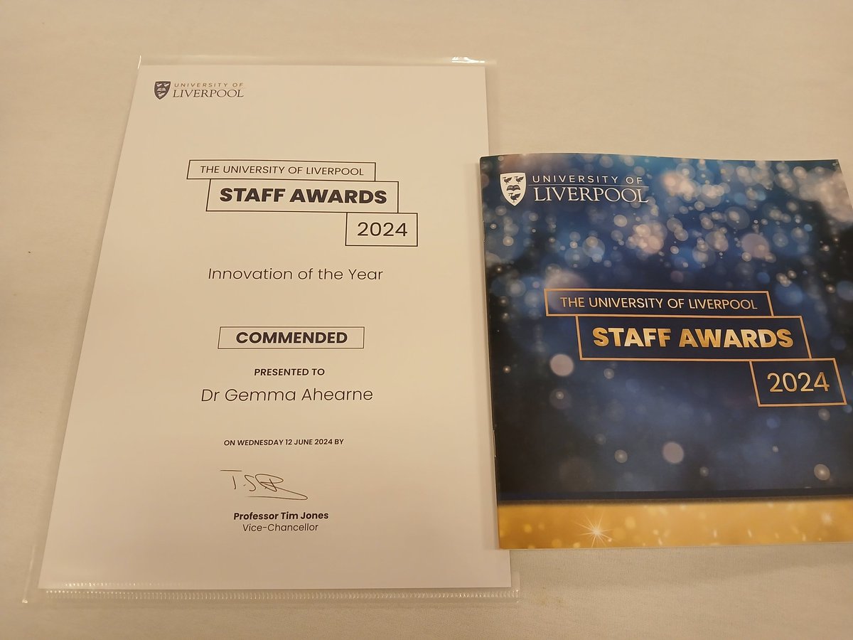 A staff award certificate and booklet