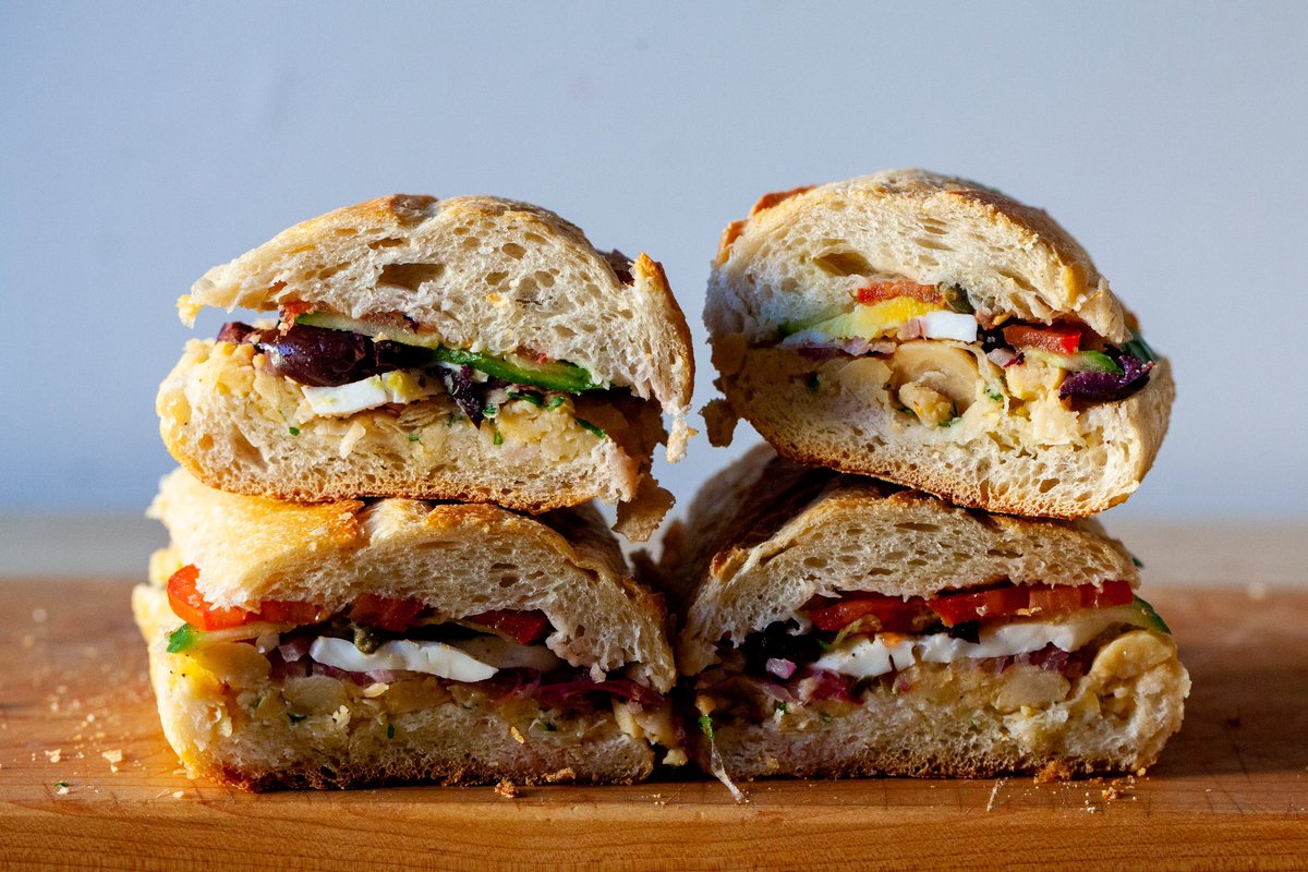 A hearty, well-seasoned and picnic basket/beach cooler-ready sandwich inspired by the pan bagnat, which is the sandwich version of a salade niçoise, I swap the tuna here with a smashed chickpea salad, add layers of crunch, richness, and seasoning. bit.ly/34qVy4W
