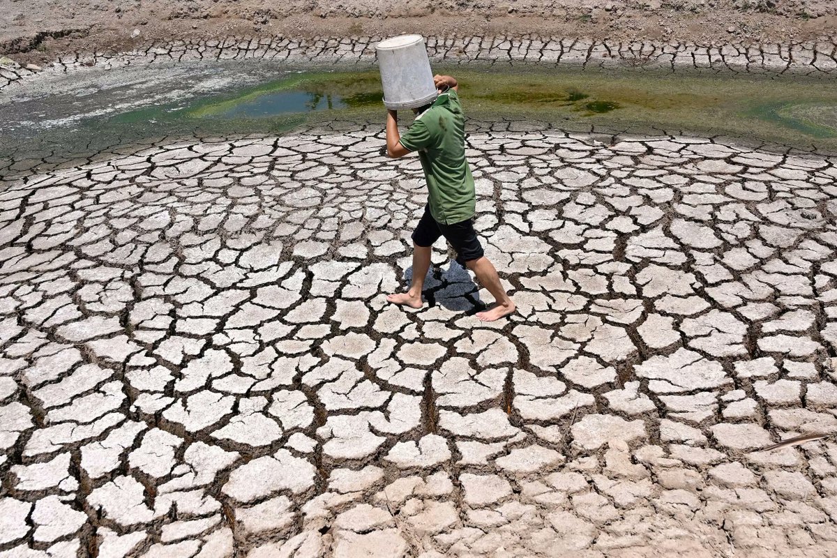 A man walks across the cracked bed of a dried-up pond in Vietnam's Ben Tre province in March 2024.

A blazing month-long heatwave has caused drought in the region, with climate change causing an average of 26 more days of extreme heat globally over the last year (Nhac Nguyen/AFP)