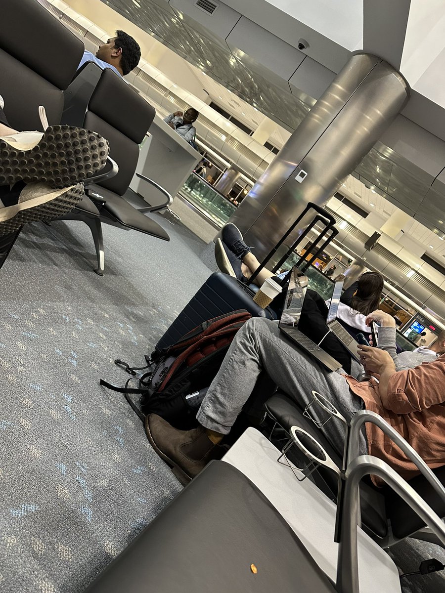 People just have no common courtesy anymore. This person has their feet across the aisle at Denver International Airport. Essentially blocking access to 6 seats including a wheelchair accessible (or it was) seat. She flat refused to move them.