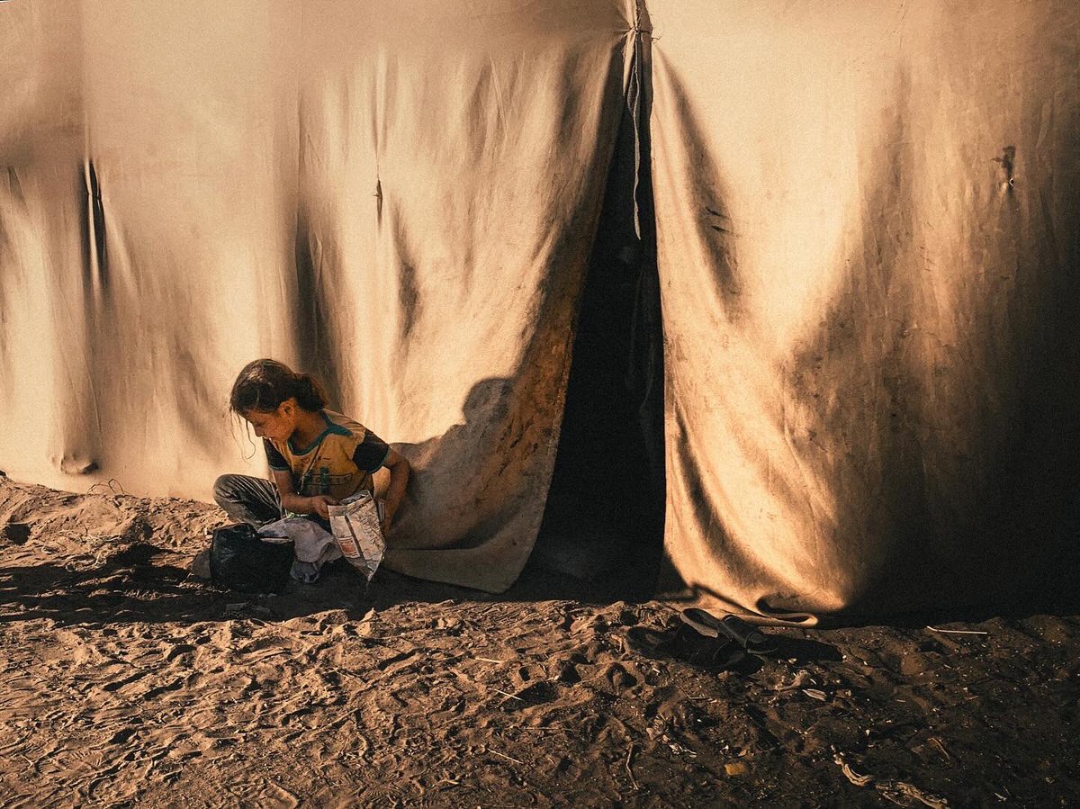 Displaced Palestinians in front of their tents in Deir al Balah. May 2024.