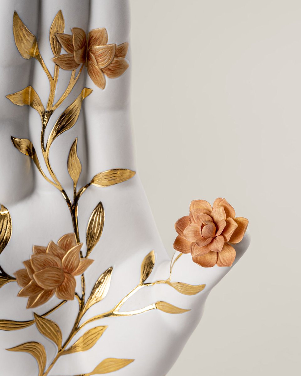 Rediscover your spiritual side with this mudra hand sculpture, decorated with minutely etched plant motifs in various shades of golden luster intertwined with the fingers and a lifelike porcelain flower on the thumb. More info at lladro.com #Lladró #UniqueCreations