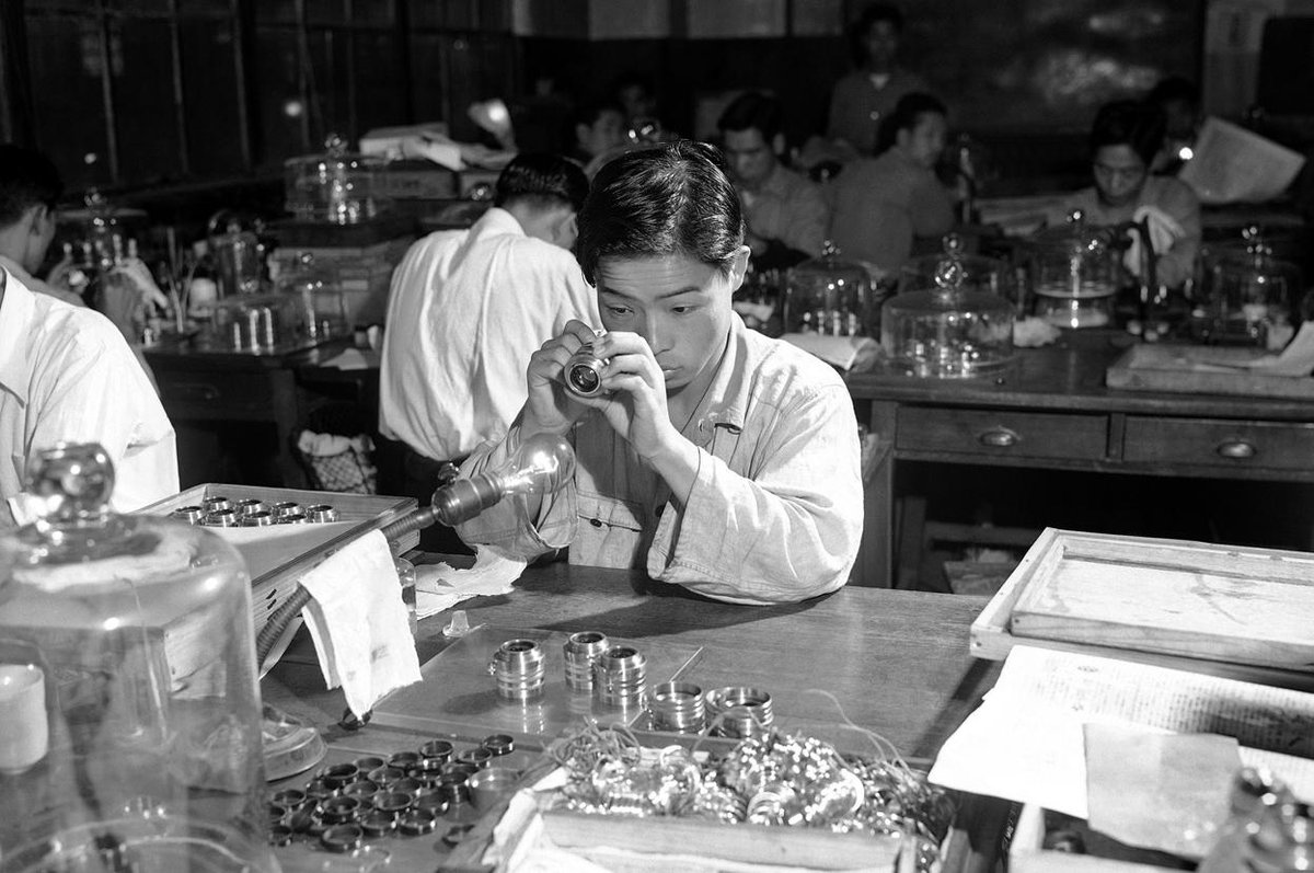 EarthHistoryPix's tweet photo. A worker inspects a camera lens at the Nikon factory in Tokyo. Japan, 1952. From u/MunakataSennin https://t.co/upRMbU3ODM