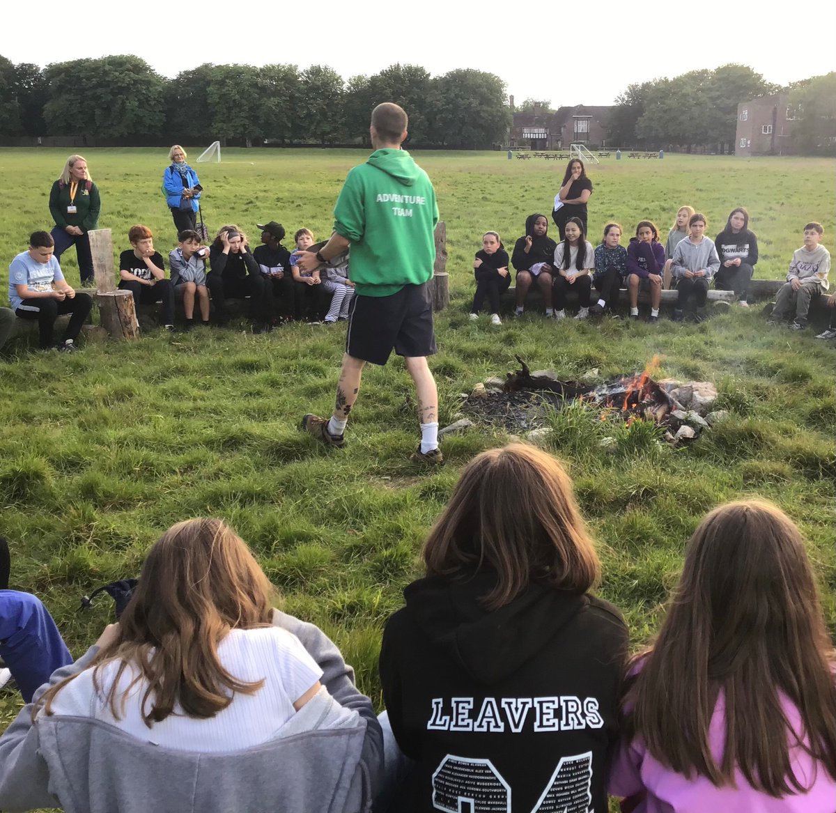 Year 6 are gathered around a campfire for their final activity of the first day. Looking forward to some marshmallows.