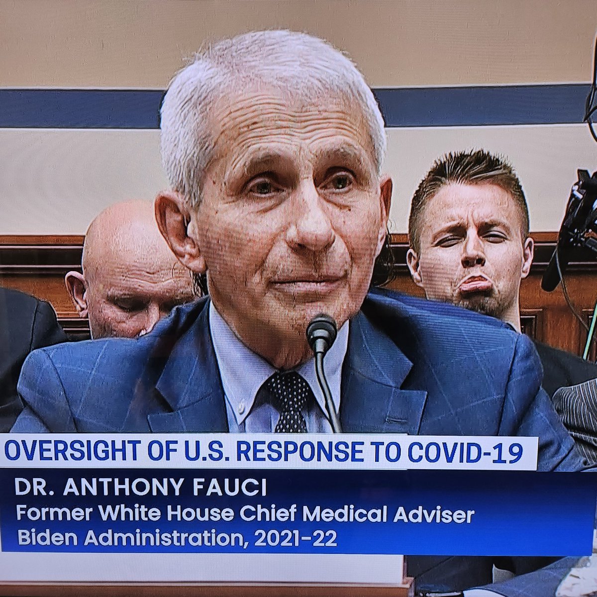 TeamTweety's tweet photo. Someone must know the name of the clown sitting behind #Fauci in the oversight hearing today? And which Republican put him there? This was when he was being asked about the death threats on his wife and daughters.  
His mom must be so proud. https://t.co/KrgUflDNwf