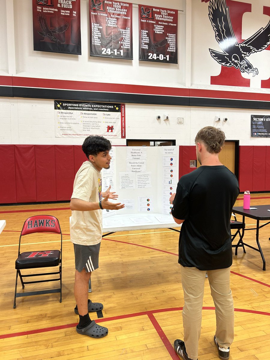 Lorenzo sharing his research on universal healthcare with Mr. Ritz #sealofcivicreadinessnight2024 📚🇺🇸