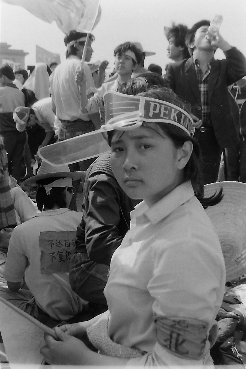 On 5th day of the hunger strike in Tiananmen Square, 1989. As I passed, this student sat up with a look of deep melancholy. She said she'd stayed awake all night for fear she might die in her sleep. I said a storm was coming, but buses were driving to the square to offer shelter.