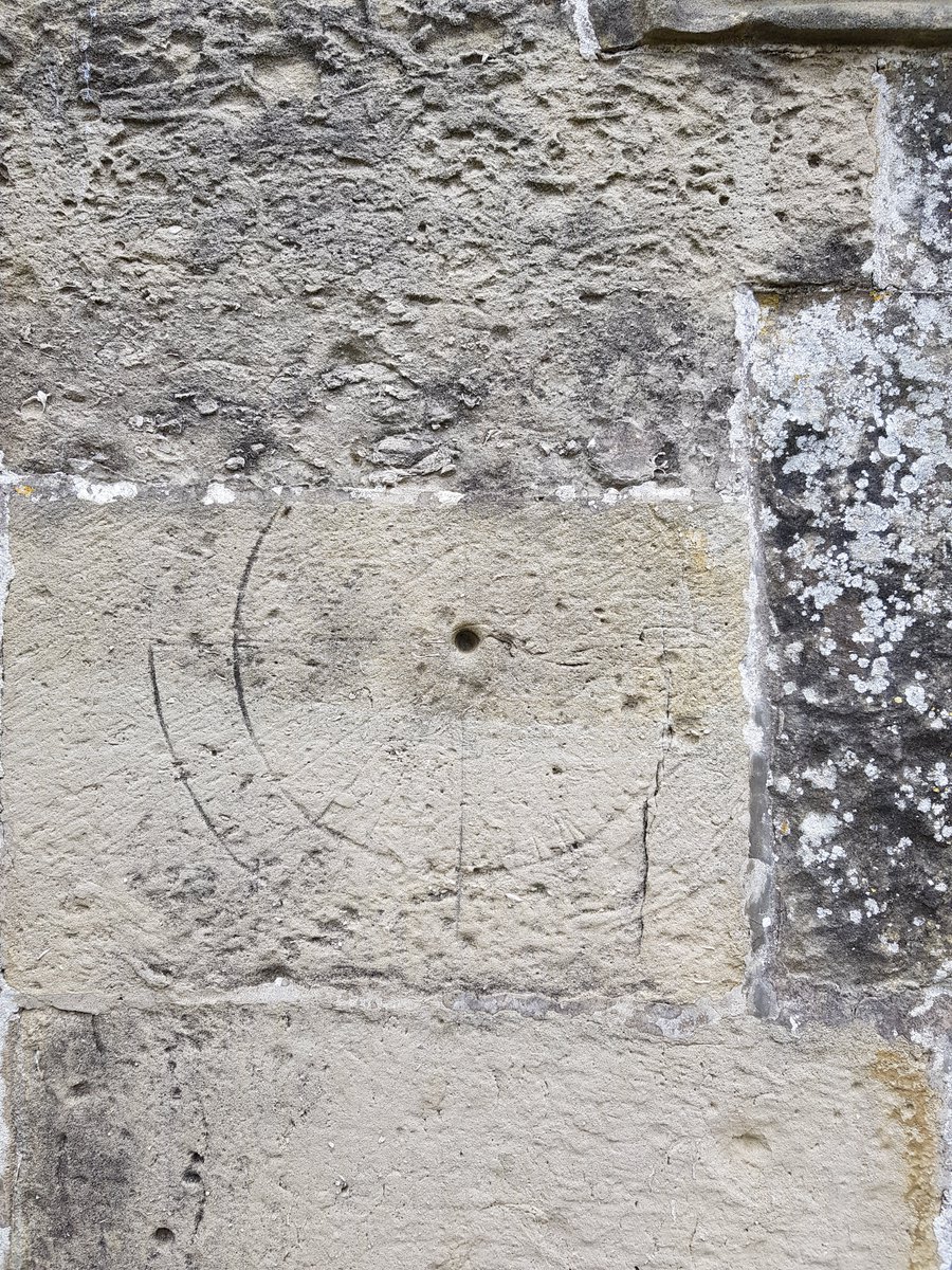 TheHistoryMouse's tweet photo. Probable scratch dial, the gradations very lightly etched within two concentric circles. Left of south porch door. Around 8cm across and top incomplete. This is a reused stone as it doesn't match the one it abuts above #GraffitiTuesday from #StMaryStapleford #Wiltshire https://t.co/ticCdI9BGF