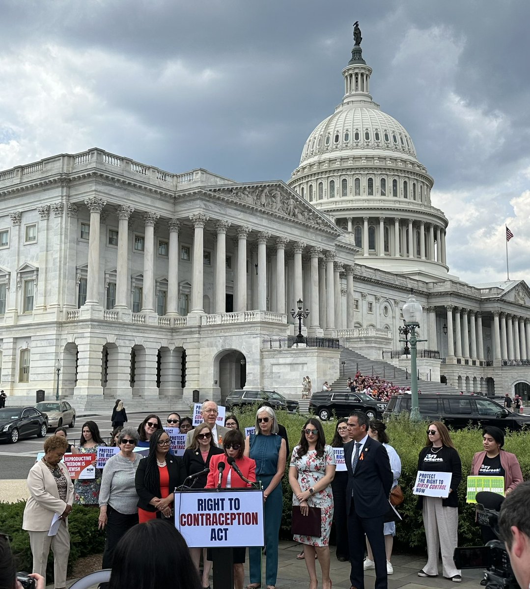 Reps standing in front of Capitol Hill