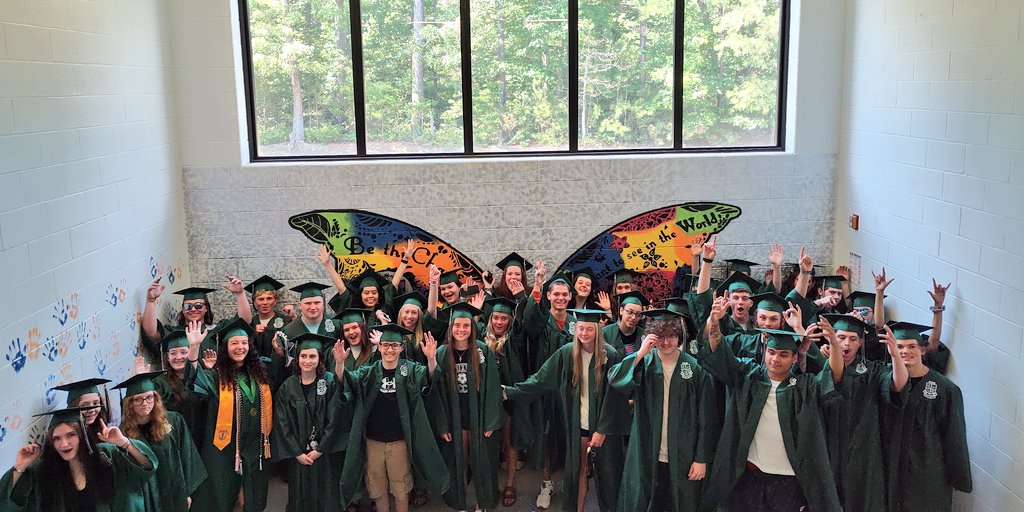 MillCreekMSCCPS's tweet photo. The 🎓s took a group pic in the very stairwell that Mrs. Bishop had them help create and place hand prints on back in  '20. @paxathletics They brought the 'best student section in the state energy' for these pics! Felt like Friday Night under the lights in The Den🔥@coachcrounse https://t.co/pF7WSgdBSU