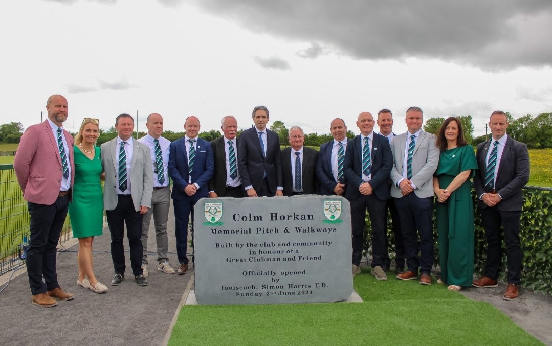 MayoGAA's tweet photo. An Taoiseach Simon Harris TD was in Mayo Sunday to official open the Colm Horkan Memorial Pitch and Community Walkways. He was joined by Minister for Justice Helen McEntee, Garda Commissioner Drew Harris, Charlestown GAA club officers players and members.  Representatives of the Mayo GAA Executice were also present. Taoiseach Simon Harris said it he was delighted to be in Charlestown as it was a day of community celebration & pride and also a day of grief at the loss of Det. Garda Horkan in the line of duty.  He said the pitch and walkways were a fitting tribute to Colm Horkan and his incredible service and impact. An Taoiseach Harris was also joined at the ceremony by Ministers of State, Dara Calleary and Alan Dillon, as well as local TDs and councillors.