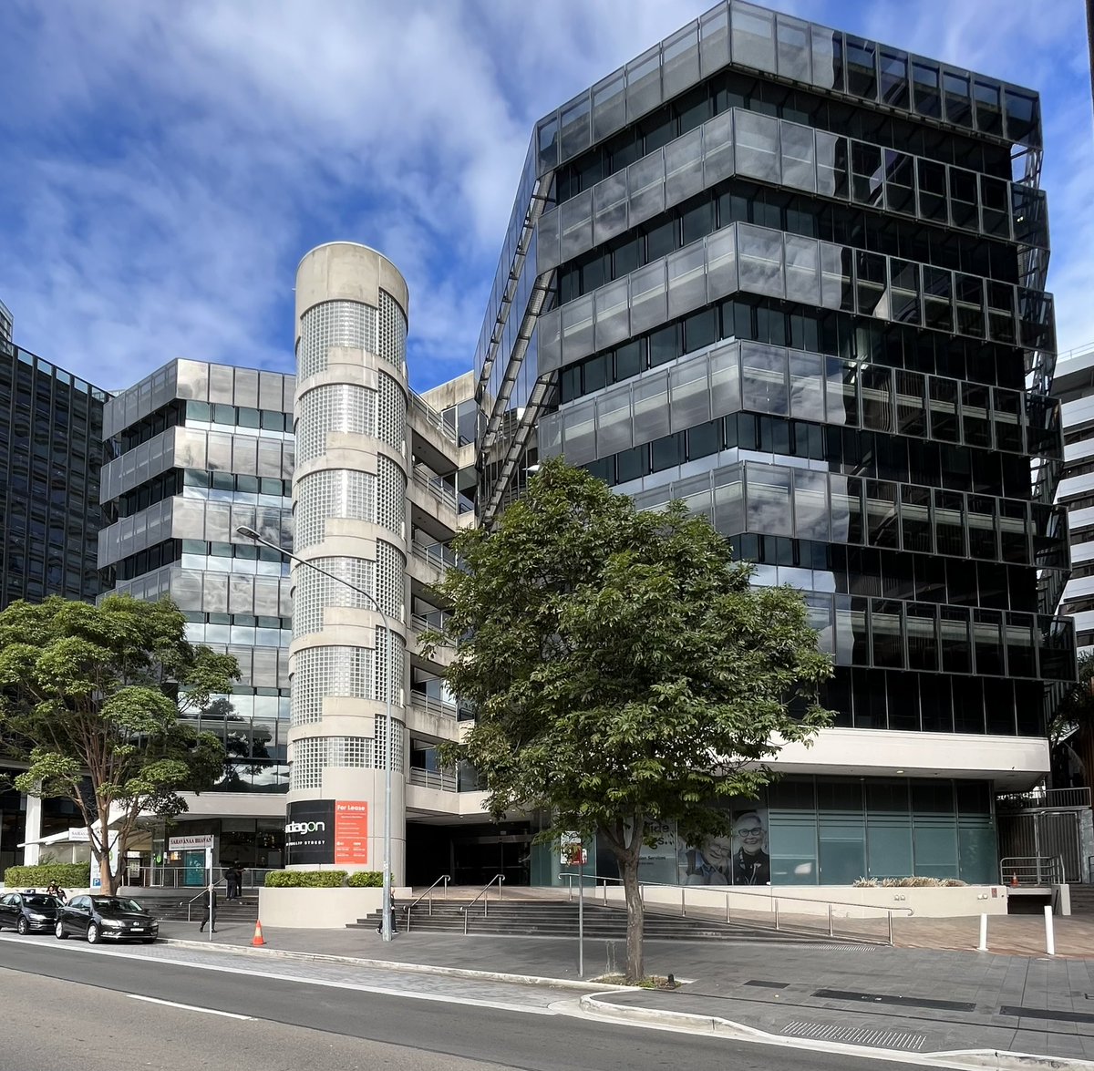 Heroic Modernism in Parramatta;
Architects John Andrews International’s Octagon office building runs block to block between George &amp; Charles St, with a central palm-planted courtyard &amp; Andrew’s signature elements.
Opened as recently as 1990, it’s at risk of demolition for towers