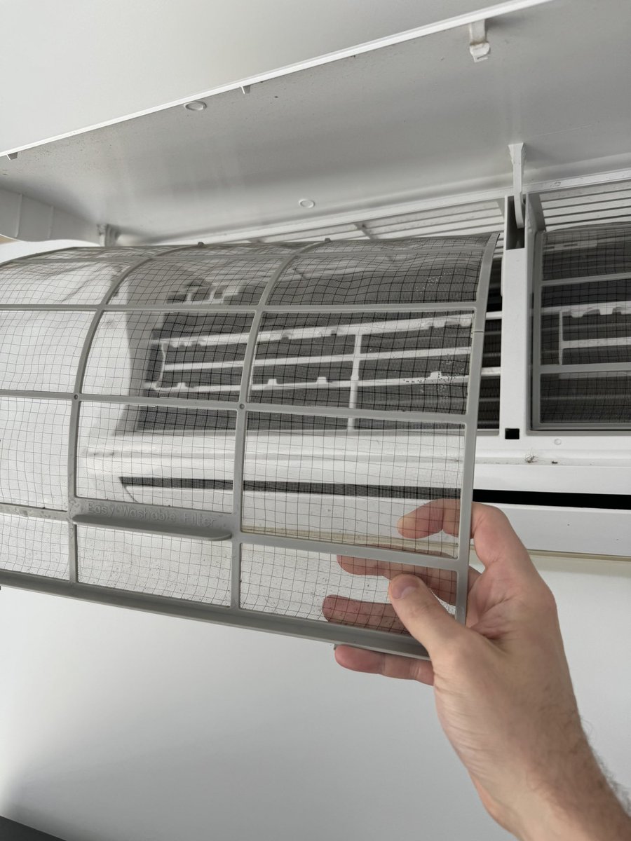 levelsio's tweet photo. First thing I do now checking into a new Airbnb is open the aircon

Filters are always insanely dirty filled with dust, mould, and whatever is in there

You can easily take them outc shower them, dry them and put them back and you have clean ACs https://t.co/DXV0Q4v67i