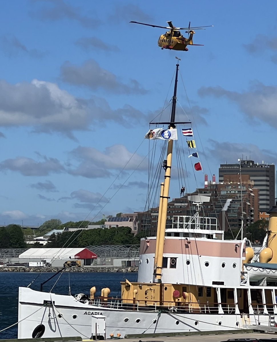 Looking splendid on the Dartmouth waterfront is ⁦<a href="/CssAcadia/">CSSAcadia</a>⁩ while a ⁦<a href="/RCAF_ARC/">Royal Canadian Air Force</a>⁩ Cormorant hovers nearby for a SAR demonstration.