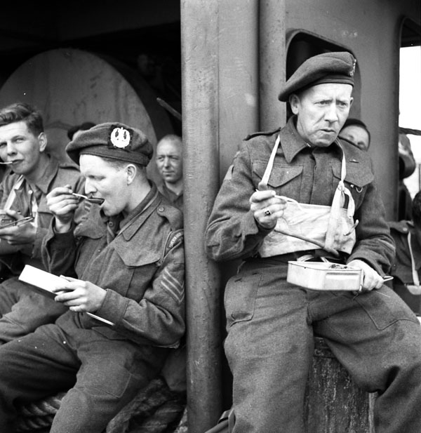 JunoBeachCentre's tweet photo. #DDay80 | 📷 Canadian infantrymen from various units, including The Cameron Highlanders of Ottawa (M.G.), eating a meal aboard ship en route to the Normandy beachhead, France, 6 June 1944 https://t.co/Y3ScQifjcK