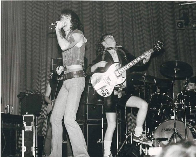 crockpics's tweet photo. Angus Young and Bon Scott performing at the Roxy Theatre in Pennsylvania, 1977 https://t.co/wKGwxQTCYM