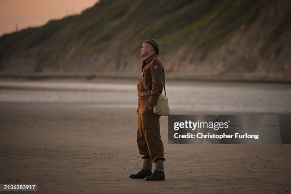 Military reenactors pay their respects on Gold Beach at sunrise in Arromanches-les-Bains, France. June 6th is the 80th anniversary of the #D-Day landings which saw troops from allied countries join forces to launch audacious attacks on the beaches of Normandy. 📸: <a href="/Chris_Furlong/">Christopher  Furlong</a>