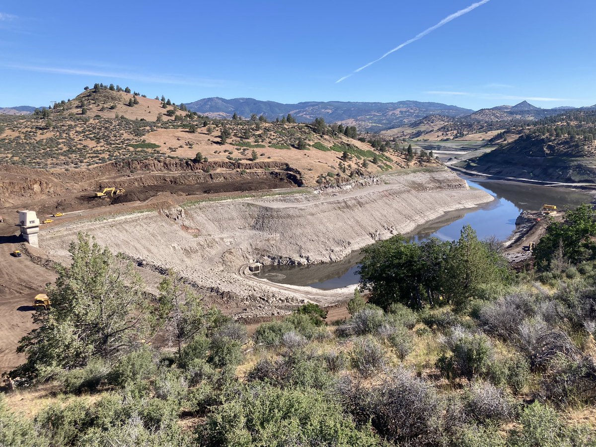 Heavy equipment scraping out Irongate Dam.