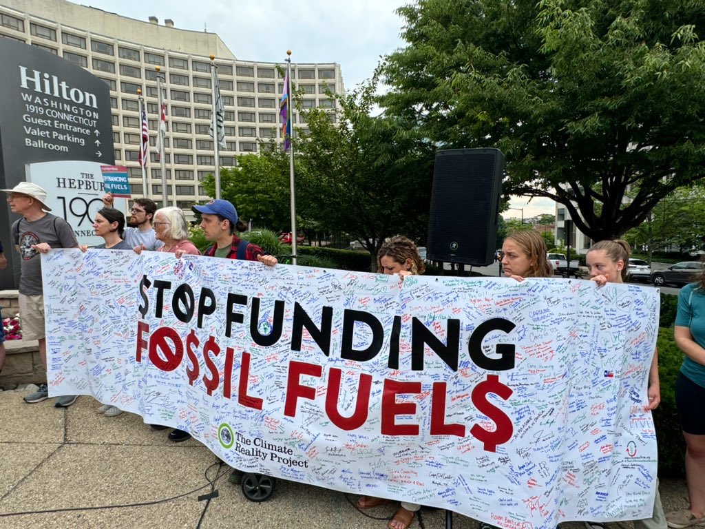 PriceofOil's tweet photo. WATCH: Major rally at @EximBankUS conference in DC, w/ businessmen in suits being forced to walk past bloody banners representing #EXIM’s deadly support for overseas oil + gas.

It’s time for EXIM to #StopFundingFossils + protect human rights!

Livestream: https://t.co/le786LaA5K https://t.co/u04HYlqGpB