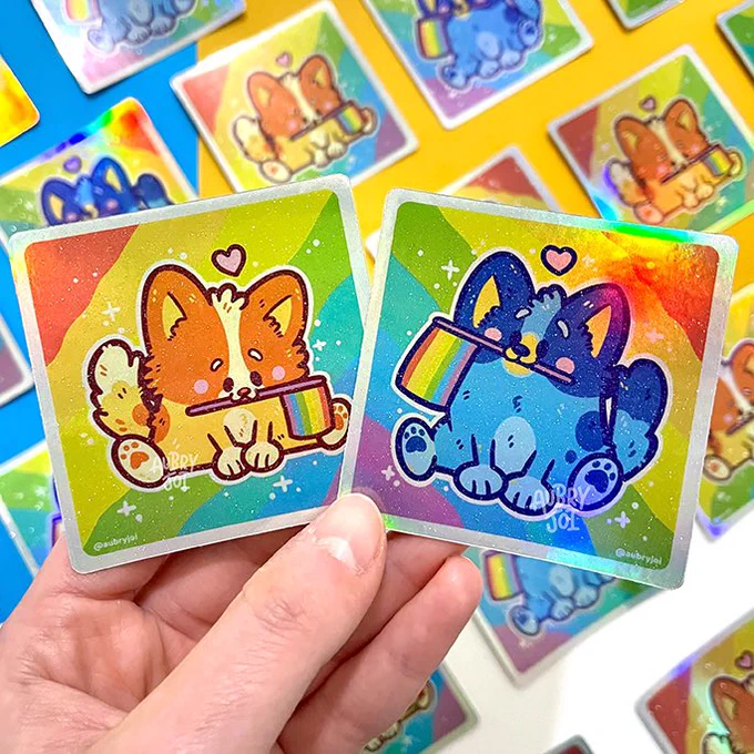 Here's a rapid-fire look at an additional assortment of designs that will be available on Saturday! We've got two new  holo Rainbow Long Cats &amp; clear Proud Eggs; plus restocks of Lil' Guy Eggs, Cherry Blossom Eggs, and even Pride Heelers (which will be on sàle)  PHEW!  