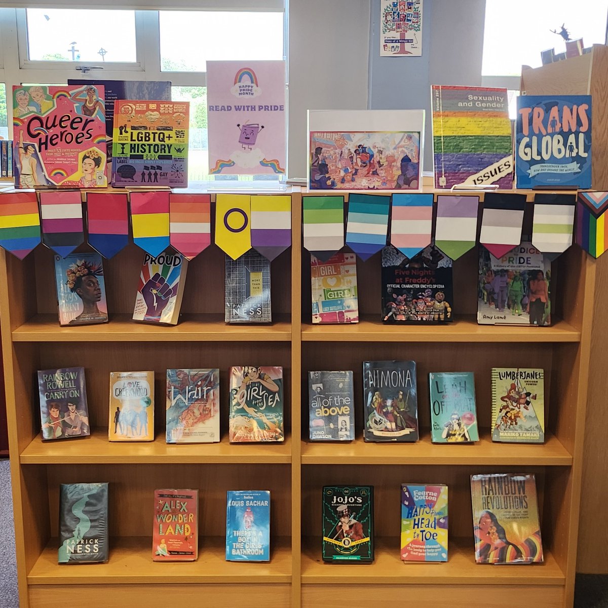 LibLourdes's tweet photo. S5 #LibraryVolunteer Dagmara did some excellent work yesterday on setting up the @LourdesSec #SchoolLibrary #Pridemonth #BookDisplay. S4 #LibraryVolunteer Rene added #Pride flags today. #ReadWithPride π³οΈβπ https://t.co/wZMiZ0qU5U