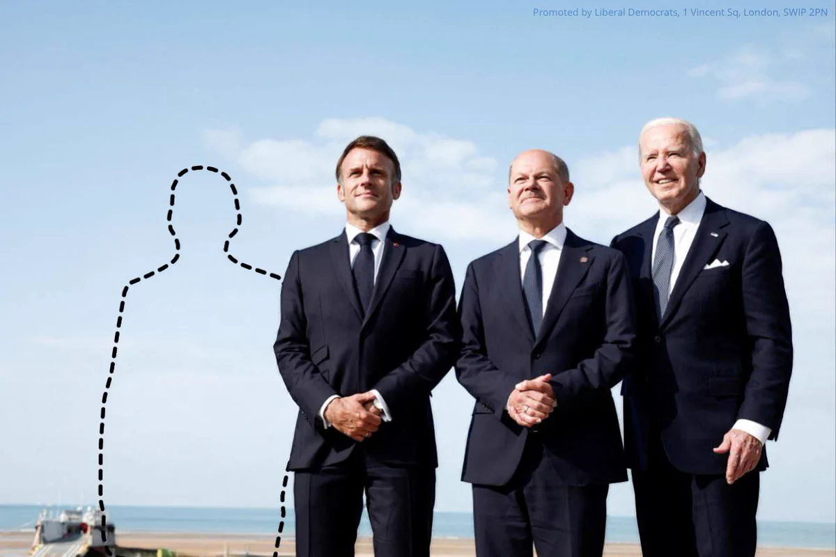 Photo of Joe Biden, Olaf Sholz and Emmanuel Macron at the D-Day 80th anniversary commemorations. In the original, David Cameron is to their left, in this image he has been replaced by a dash-line cutout to represent Rishi Sunak's absence.