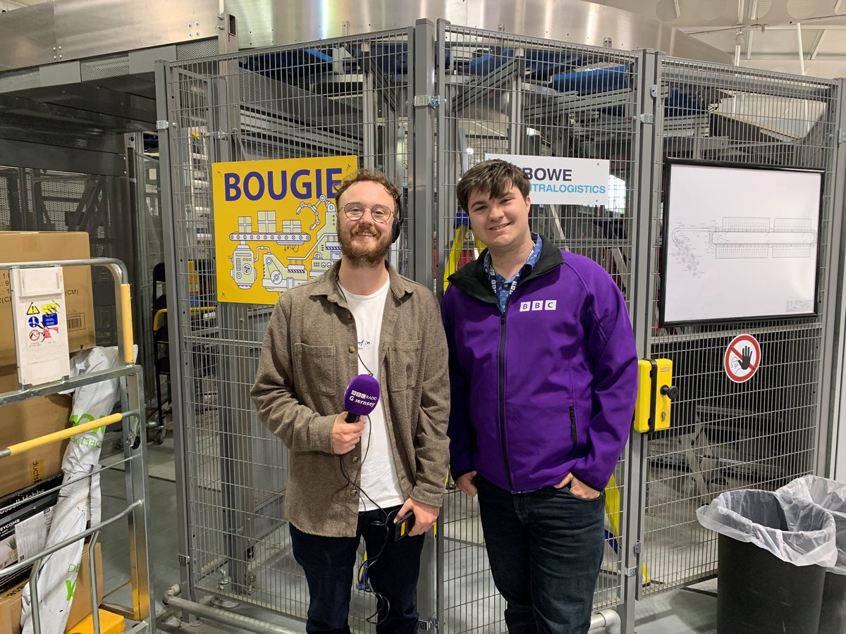 GuernseyPost's tweet photo. We were thrilled to have Tim Hunter and Archie Ward from @BBCGuernsey join us this morning, running their radio breakfast show from our sorting office. Listen back later on BBC Sounds to hear them shining a spotlight on some of our amazing posties! #BBCRadioGuernsey #PostalPride https://t.co/uu178fqyKk