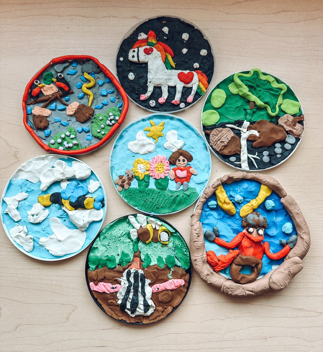 After participating in an author study exploring Barbara Reid, students were inspired to create art of their own. Each student was given a recycled plastic lid to frame their art. As you can see, each piece is individual and tells a story. Thank you <a href="/barbreidart/">Barbara Reid</a> for inspiring us!