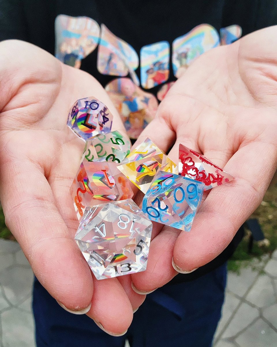 iamchubbybunny's tweet photo. Happy Pride! You can support the Trevor Project Pride, and your love of DnD with these awesome dice from DnD and this adorable shirt for sale at @mtg_pro_shop, with all proceeds from both going to The Trevor Project.

Thanks to @Wizards_DnD and MTGpto for the gifts! https://t.co/VcDyhIIVRK
