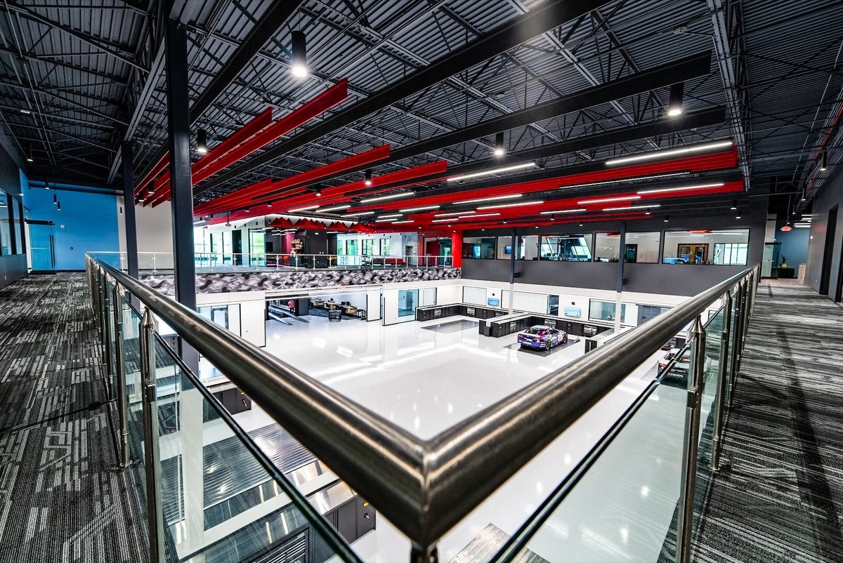 FOS's tweet photo. A look inside Airspeed—the new North Carolina HQ for Michael Jordan and Denny Hamlin’s 23XI Racing:

• 114,000 sq. ft.
• Weight room, sauna
• MJ and Hamlin memorabilia
• Windows with a 23-degree tilt
• Conference room with 45 pairs of Jordans https://t.co/Ec1lqECF5V
