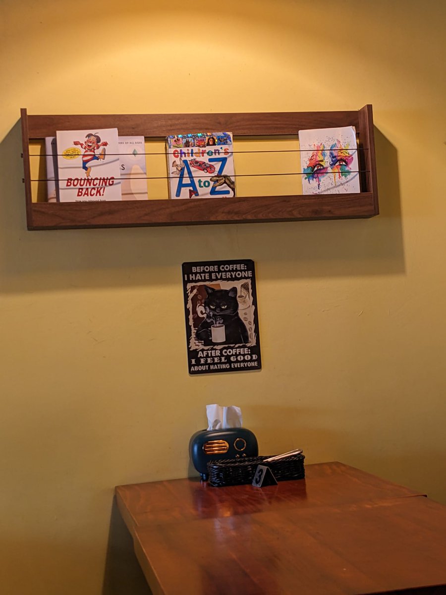 TheBatBotLab's tweet photo. Cold-eyed caffeinated cat looking from the wall of a cafe in Kiulap, #Brunei. Photo: Chi https://t.co/aBzNshGFe0