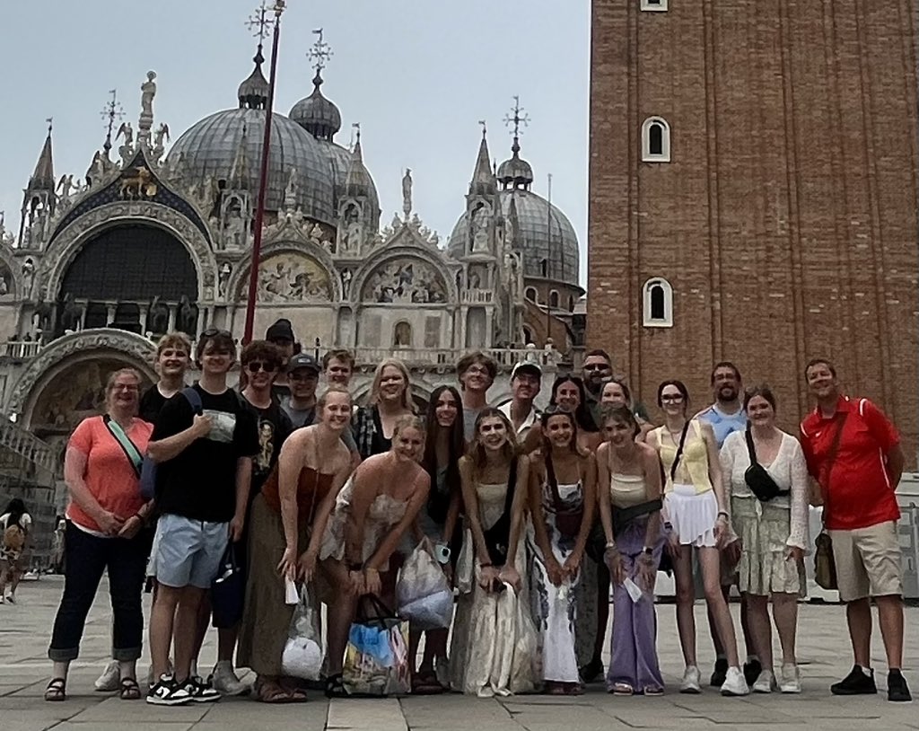 bowk13's tweet photo. Wildcats in Venice. St. Mark’s Square is the public square of Venice. Dominated on the eastern end by St. Mark’s Basilica as well as St. Mark’s Clocktower. The basilica is connected to the Doge’s Palace which is where the rulers of Venice lived. #BowkerEurope https://t.co/N9qp3RoxbX