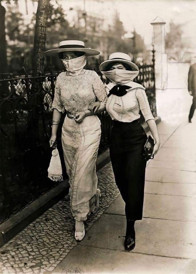 Two women out in a walk with a gauze face covering 1918