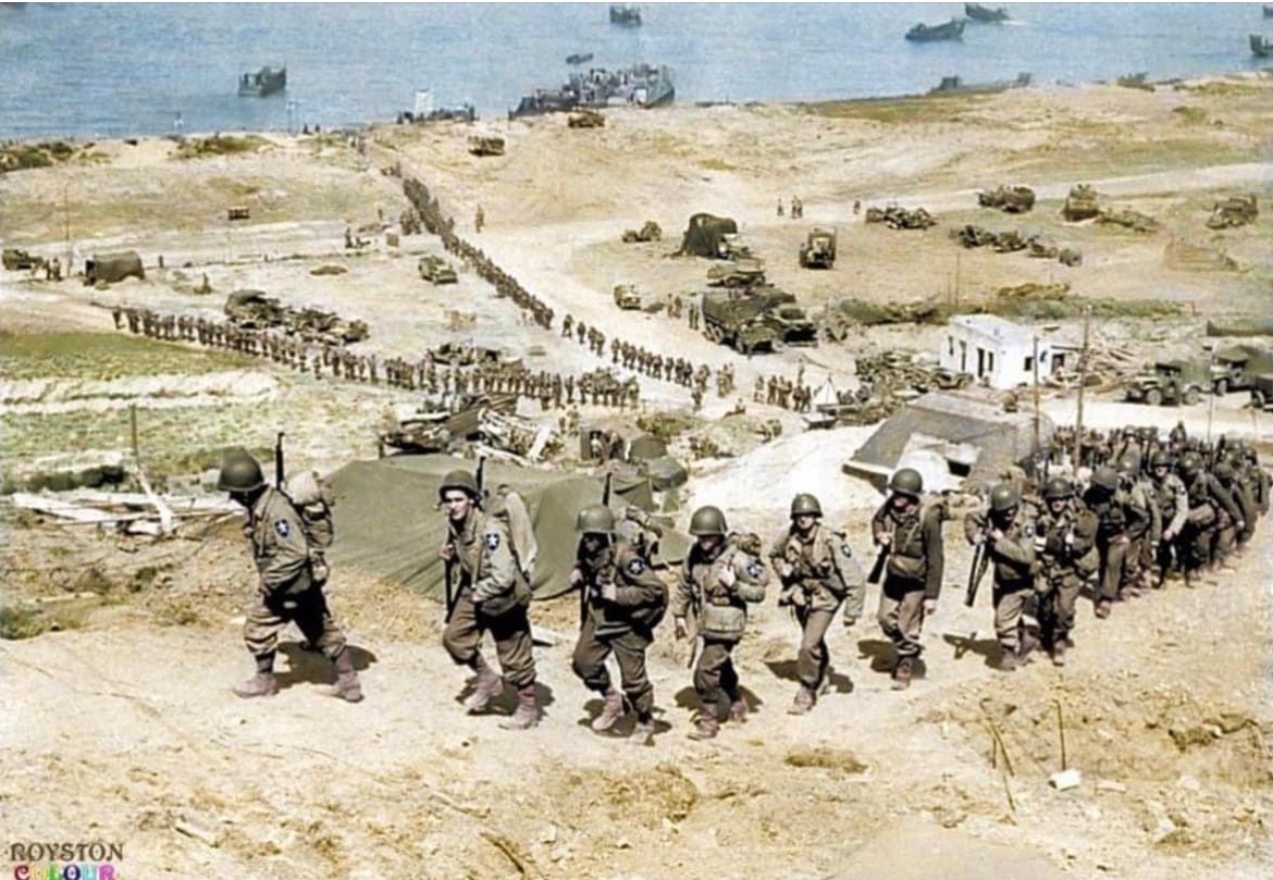 Jason_R_Burt's tweet photo. In June of 1944, soldiers of the 2nd Infantry Division march up the bluff in the Easy Red sector of Omaha Beach, Normandy. 🪖 https://t.co/5qM624ouGI