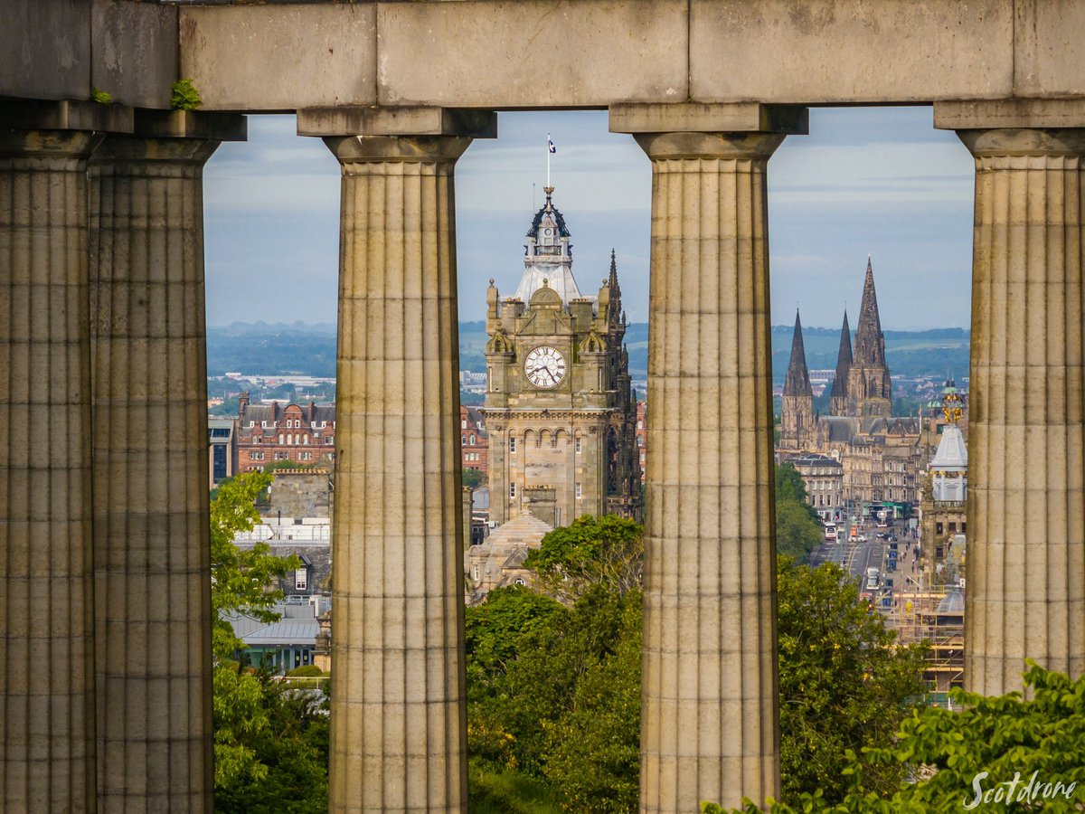 scotdrone's tweet image. The iconic Balmoral Hotel Clock Tower viewed from an unusual angle through the National Monument of Scotland on Calton Hill in Edinburgh 
#edinburgh #visitedinburgh #scotland #visitscotland #drone
