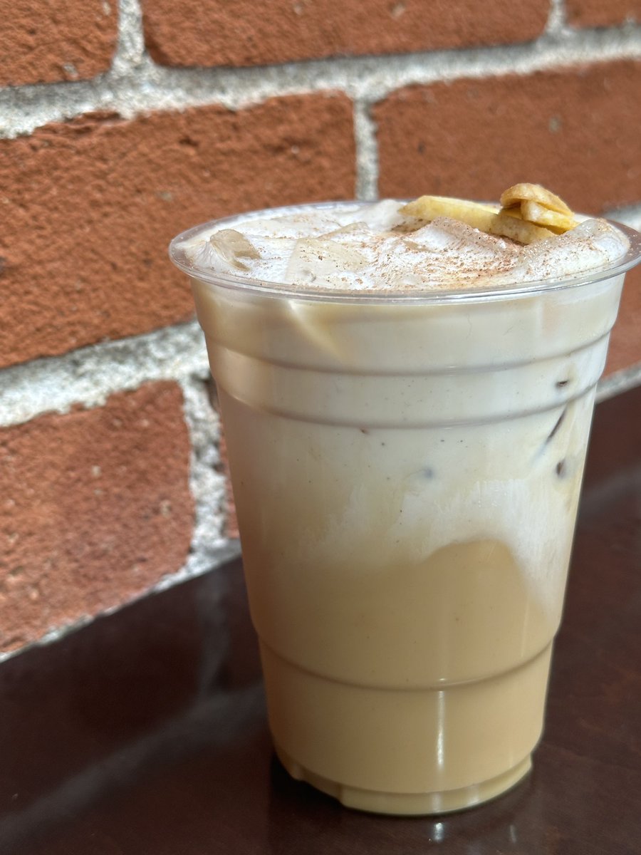 Banana cream latte with oat milk topped with cinnamon and banana chips