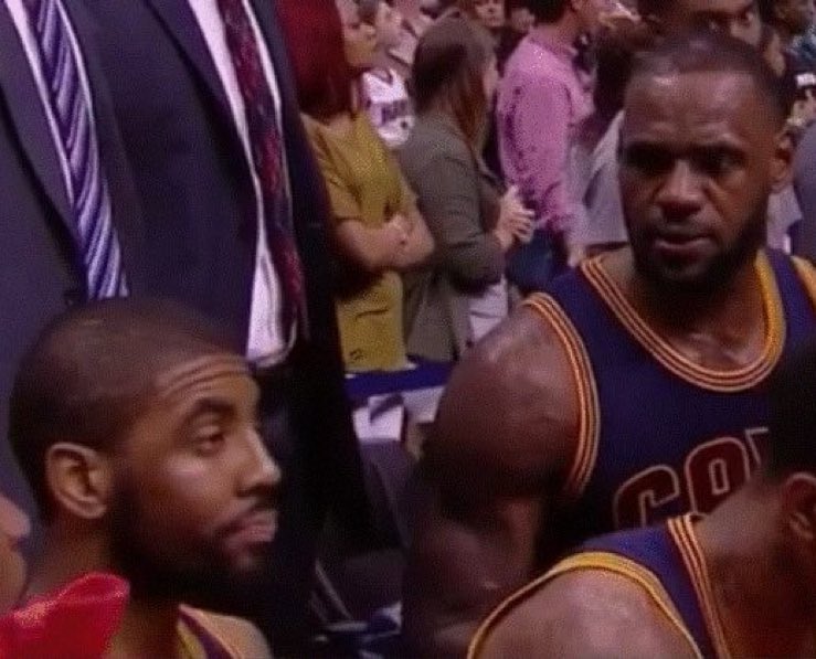Luka Doncic looking at Kyrie Irving in the locker room after Game 2
