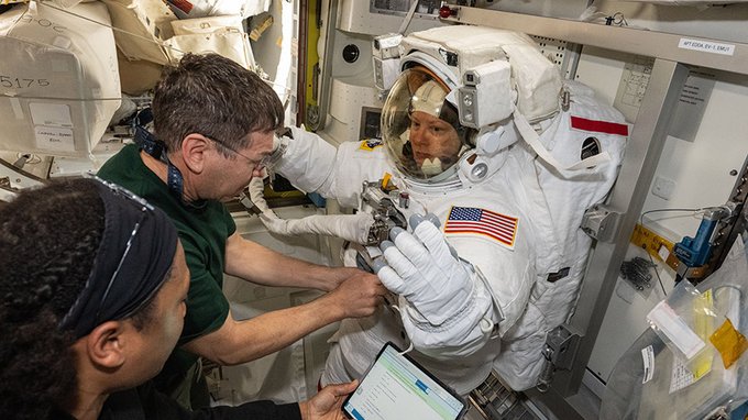 Expedition 71 Flight Engineers (from left) Jeanette Epps and Mike Barratt assist Expedition 71 Flight Engineer Tracy C. Dyson, all three NASA astronauts, during a spacesuit fit check inside the International Space Station's Quest airlock.