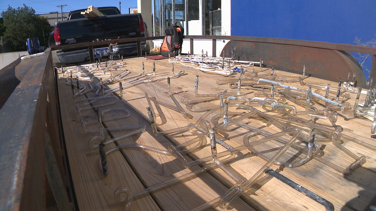 Nestor Ilagan shows his son the sign at Friedman's Army Navy Outdoor Store. Nestor used to post the messages on it. Friedman's closes after 75 years this week. The sign is being restored by Liquid Fire Vintage Neon. Nestor says the sign has been at Friedman's stores since 1955.