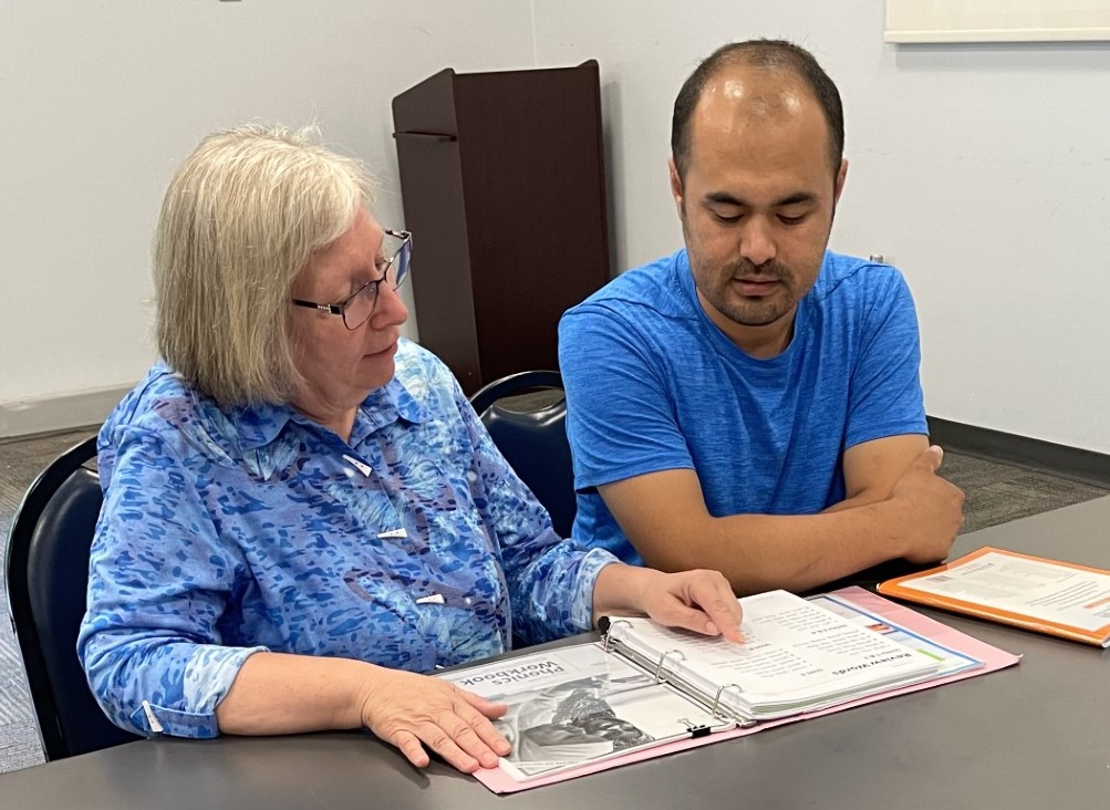 Literacy_4_Life's tweet photo. Gholam works with his tutor on English literacy skills at Grissom Library in Newport News. Like many other learners, he’s developing the skills he needs to integrate and thrive in his new home. Find out more about becoming a tutor at  https://t.co/LZd0f3Lblu. https://t.co/LaomBe6yFL
