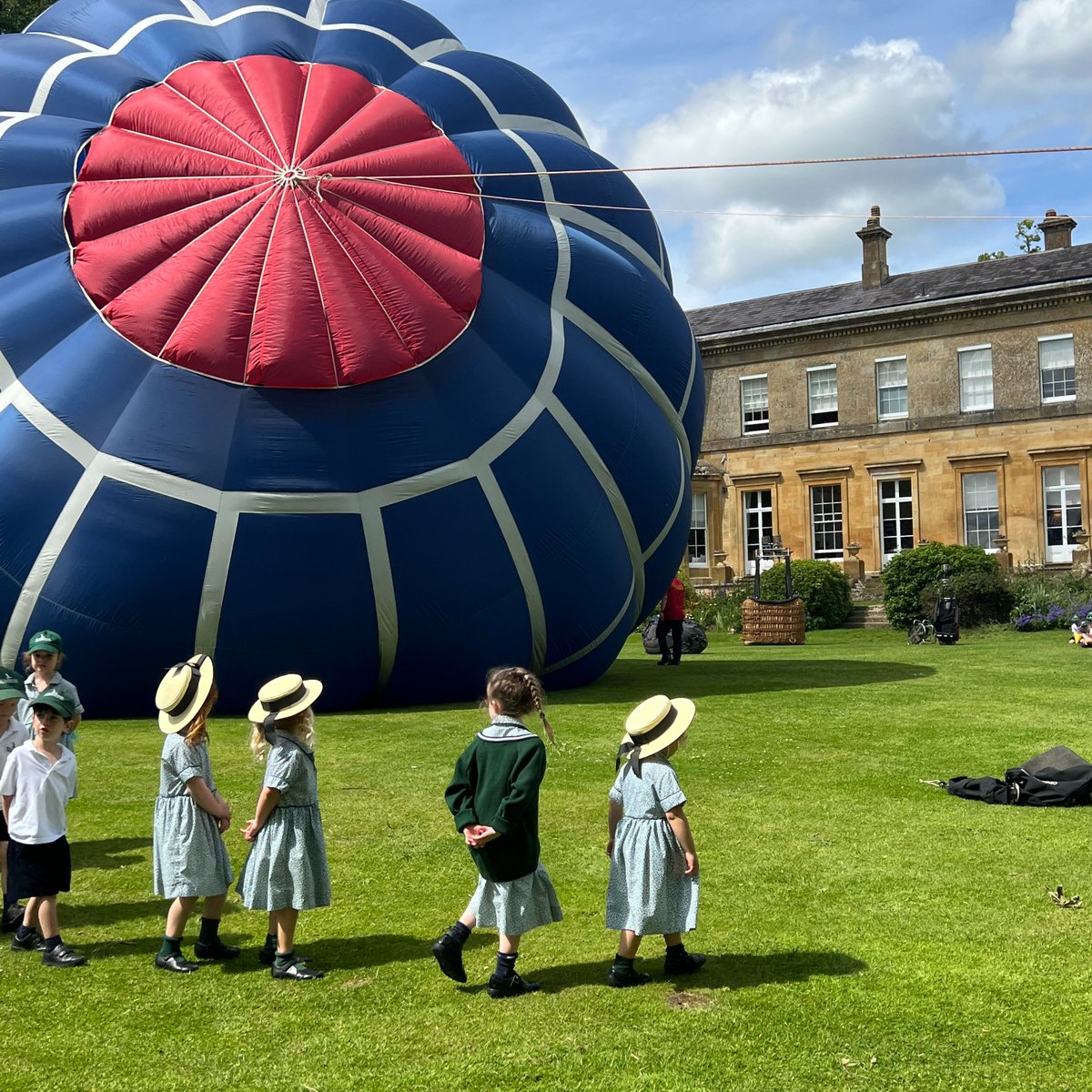 KitebrookSchool's tweet photo. The EYFS children enjoyed a visit from two local hot-air balloon pilots. The children explored different types of balloons; a Hopper and a Basket. They explored inside the basket and discussed how the burner helped it fly. #kitebrookprep #cotswolds https://t.co/Dqw0fYSGNH