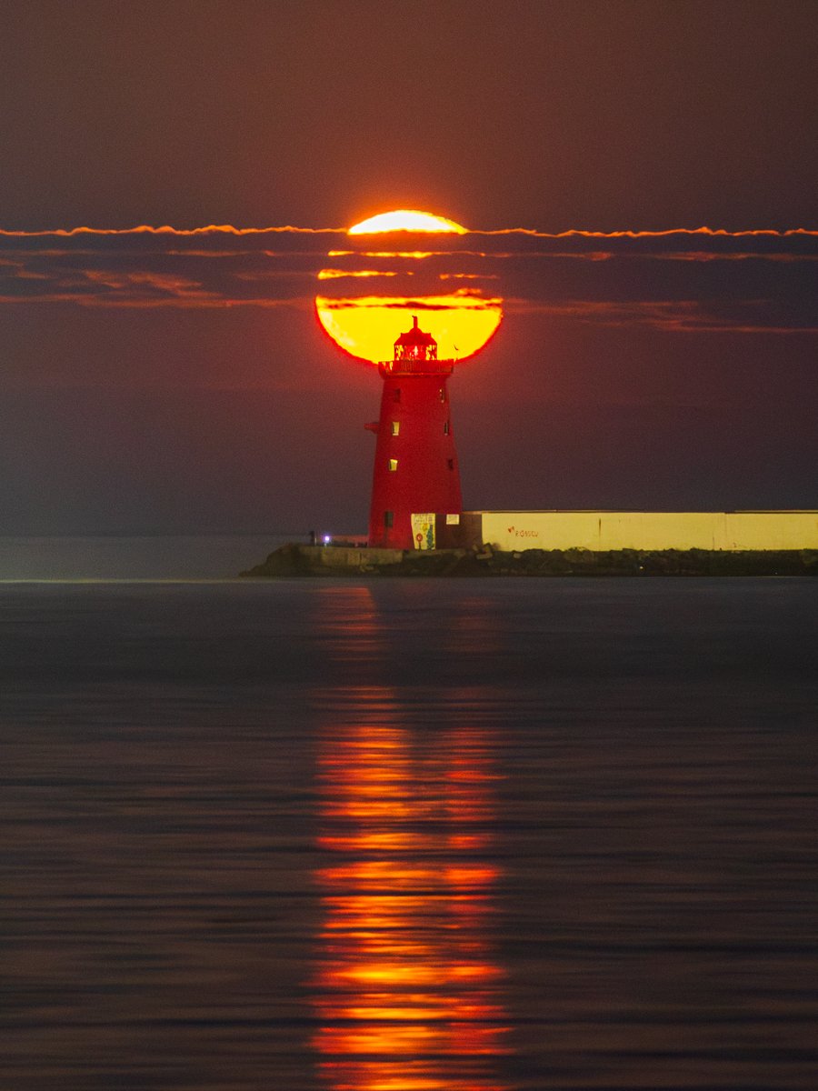 Last night's moon lined up with Poolbeg Lighthouse from Clontarf.